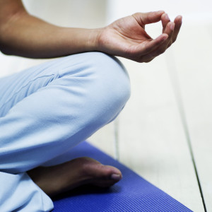 Young Woman Meditating on the Floor --- Image by © Royalty-Free/Corbis