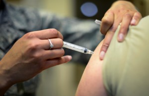 U.S. Air Force Staff Sgt. Bianca Raleigh, 31st Medical Operations Squadron allergy and immunizations noncommissioned officer in charge, administers a patient’s shot March 23, 2015, at Aviano Air Base, Italy. In addition to providing patients with required vaccinations, the immunization clinic offers allergy shots and air allergen skin testing. (U.S. Air Force photo by Senior Airman Areca T. Wilson/Released)